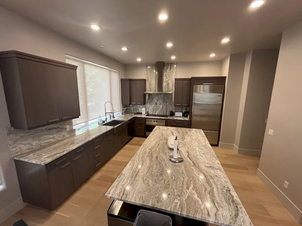 Completed kitchen remodel with dark cabinets and island